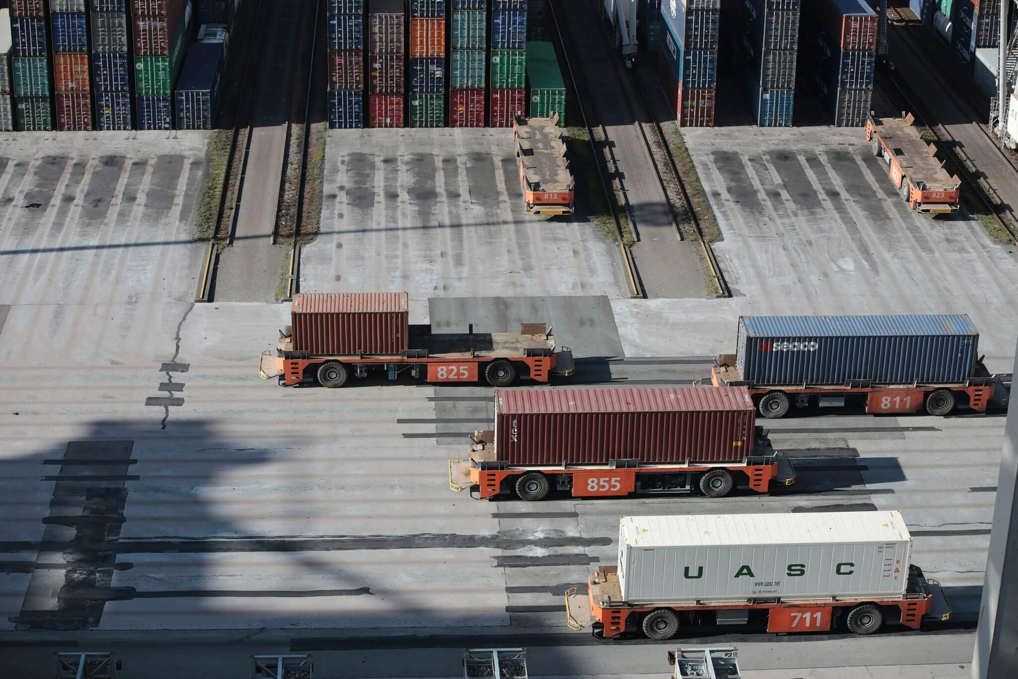 Containers and parked trucks at a Bangladesh port terminal